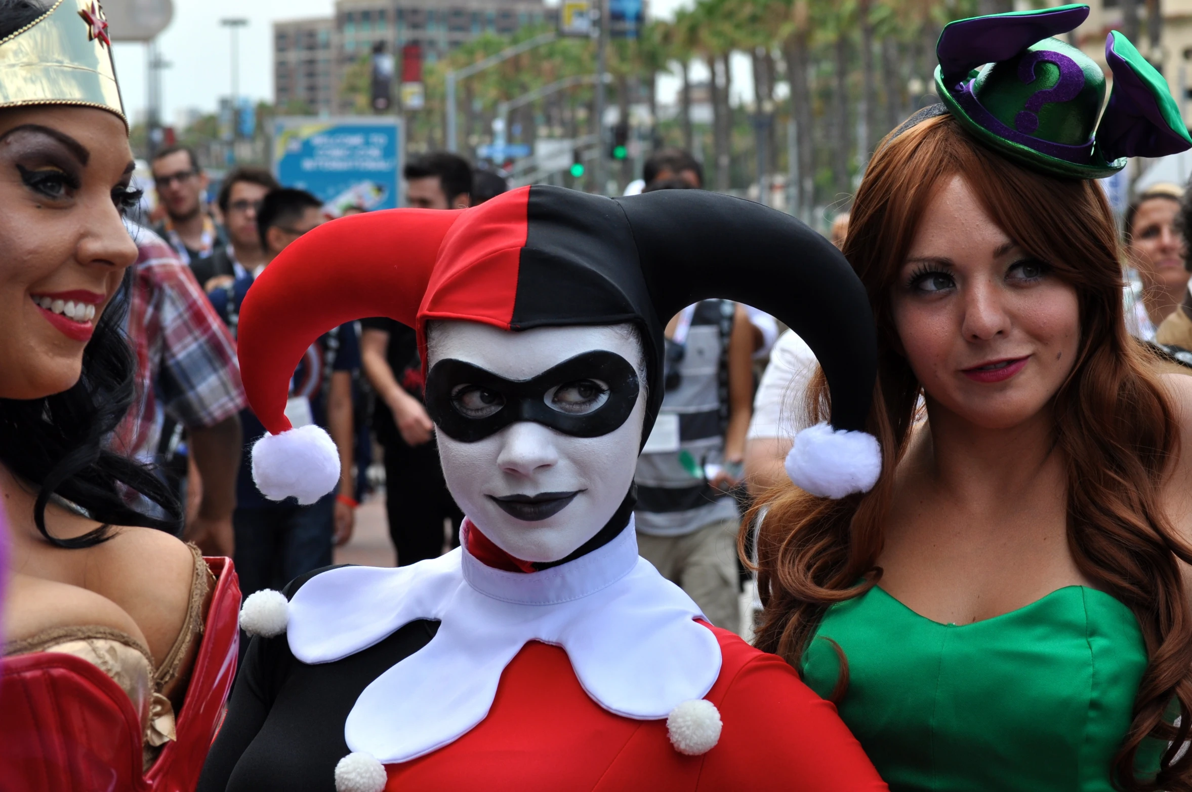 two women in costumes with faces painted in white and black, one wearing green