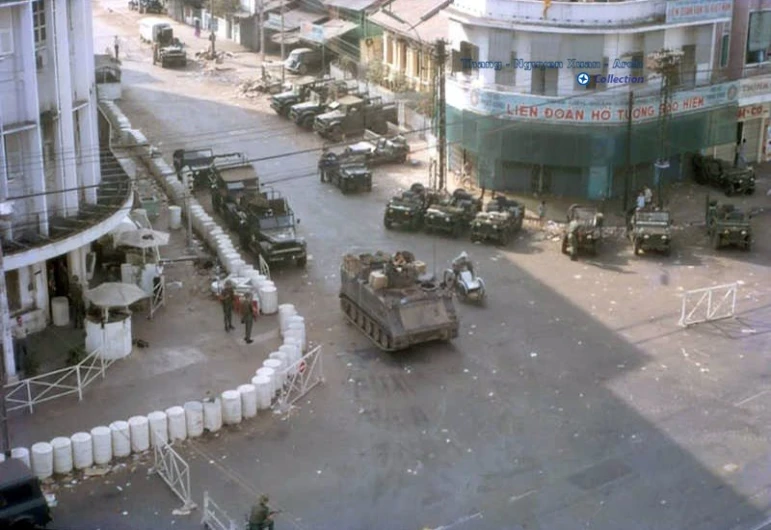 an aerial view of several military tanks and a street