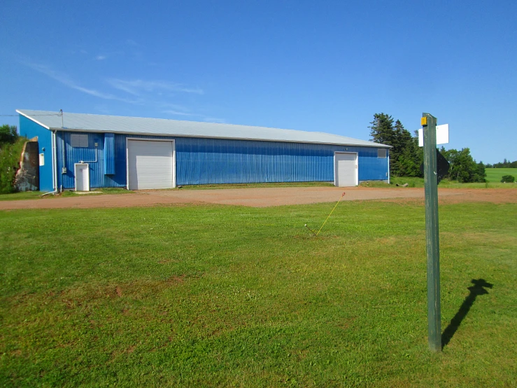 a tall pole with two signs in front of it