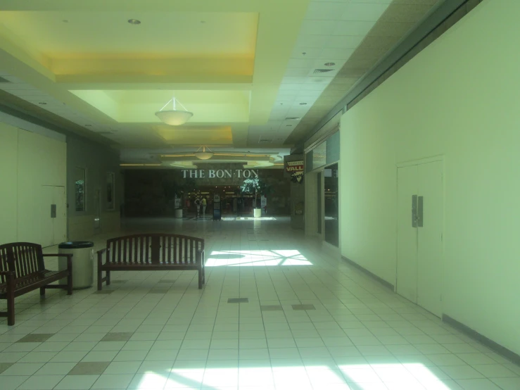 this po shows a white tiled hallway with benches and the doors are open