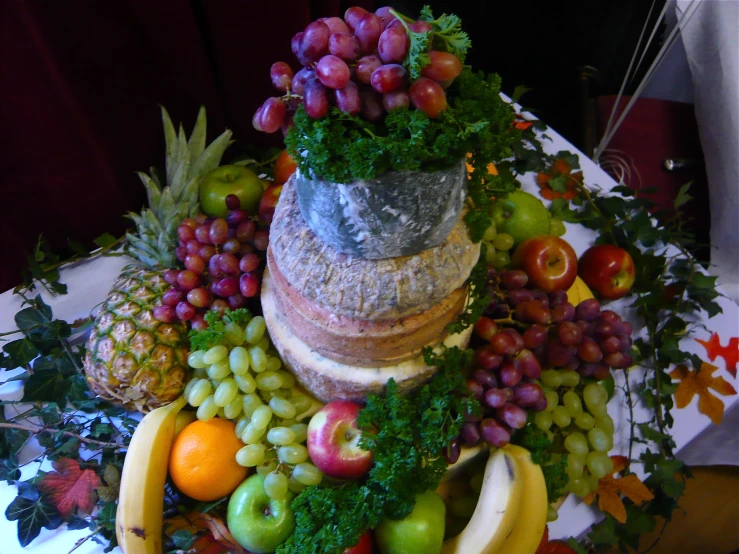 a round sculpture made of various fruits and vegetables