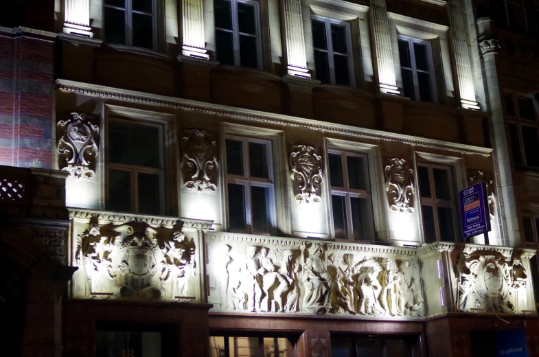 the outside of an art deco building at night