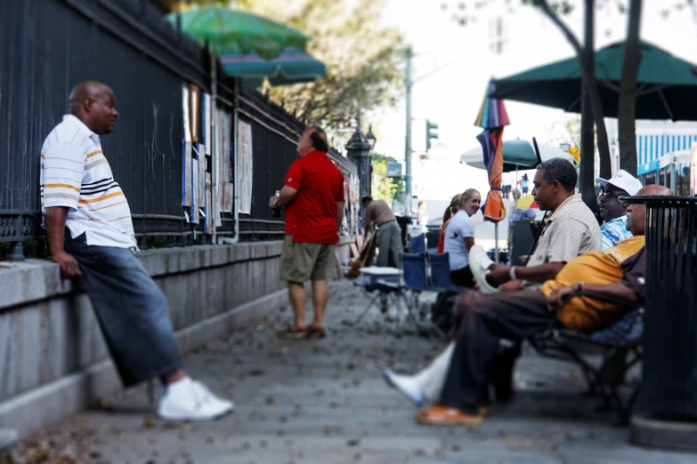 the men are sitting outside on the benches