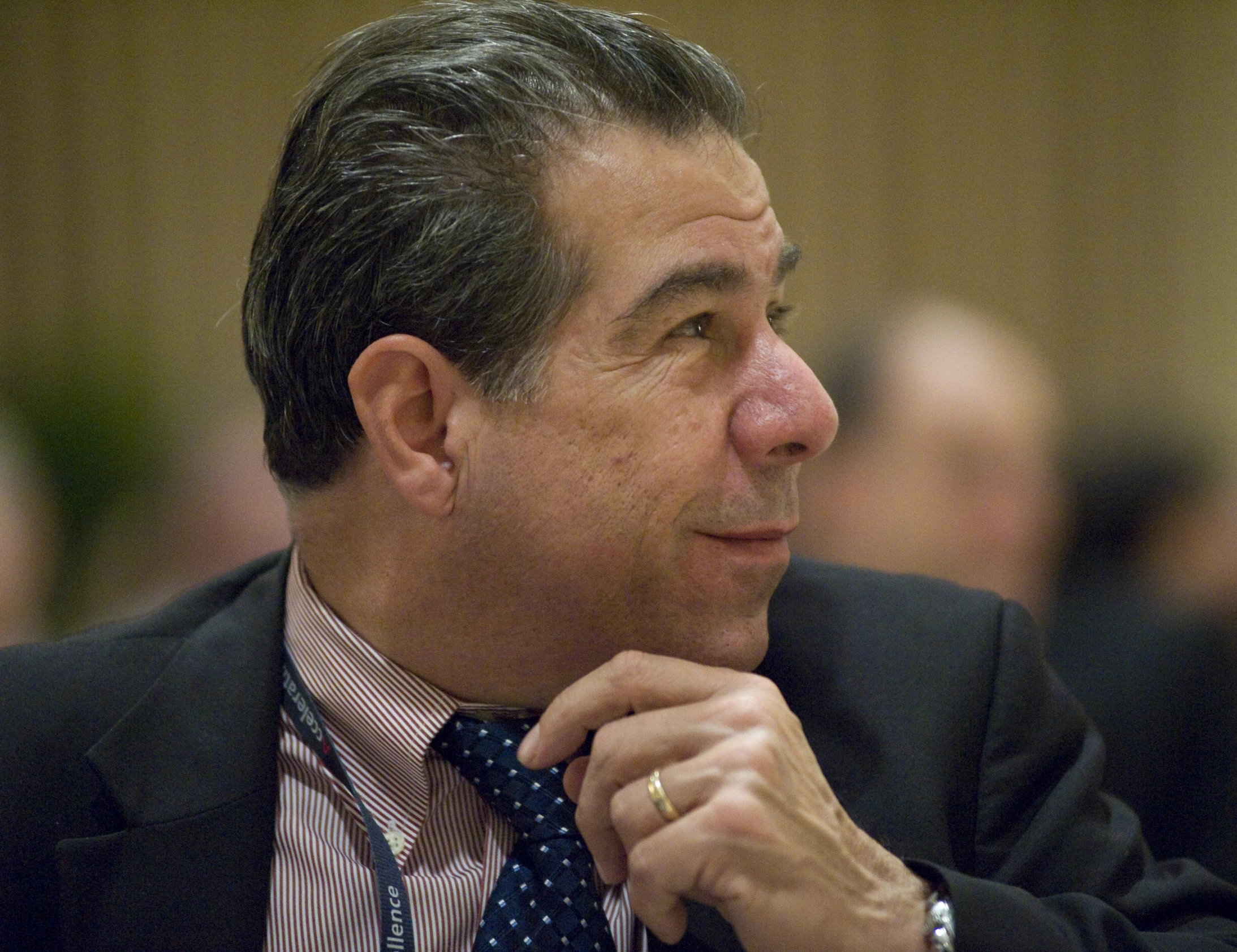 a close up of a man with a suit and tie