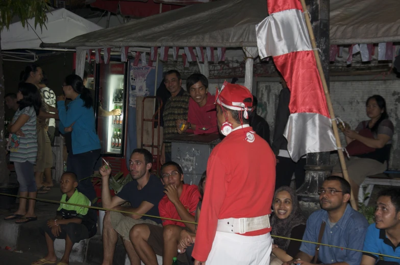 man in red and white outfit holding a flag