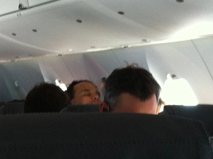 people on an airplane looking out the windows