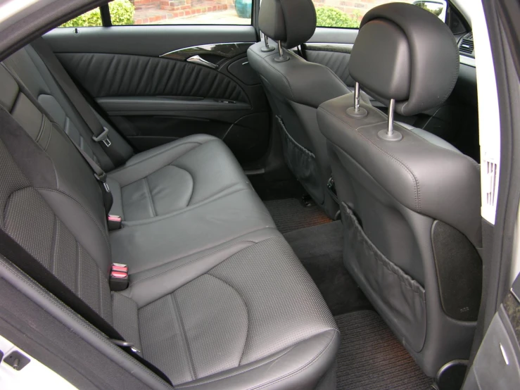 back seat in vehicle with large window, seats folded down and the back seats folded down