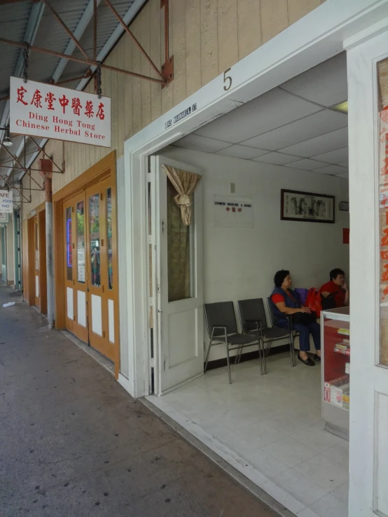 a person sitting at a table next to a couple of windows