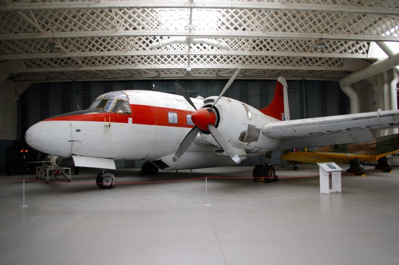 a plane parked inside of a hanger in a building