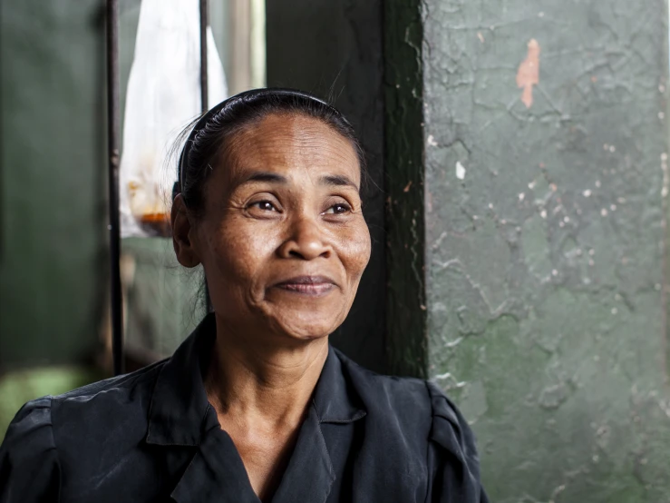 an older woman smiling with a concerned look on her face