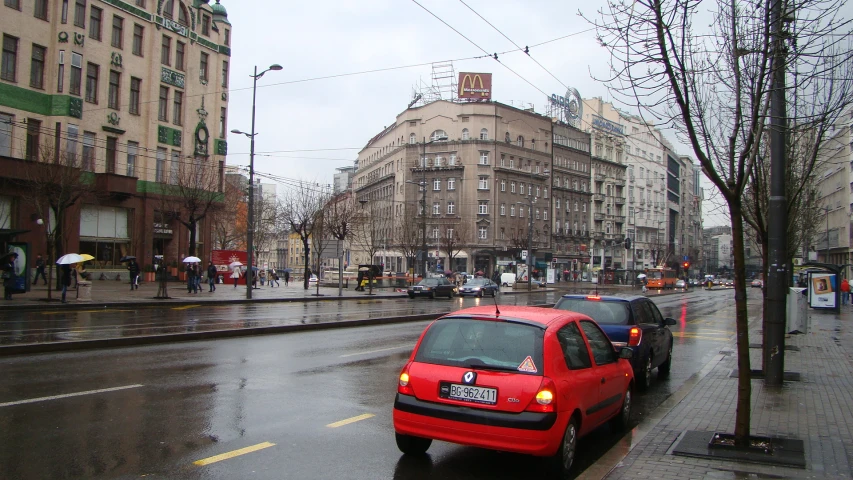 the red car is stopped at a stop light