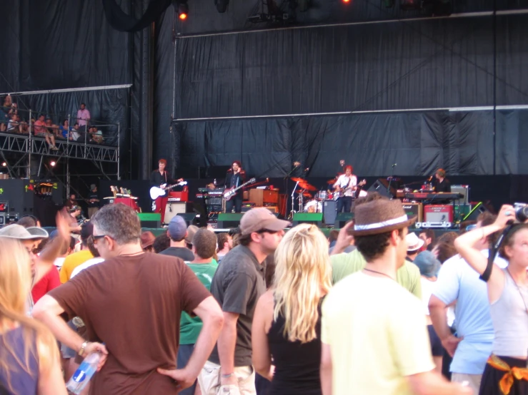 many people in the audience watch a music band