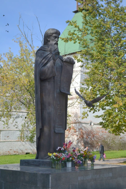 a statue on top of a granite block in a park