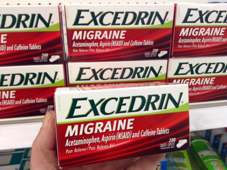 several packages of excedrin are on display for sale