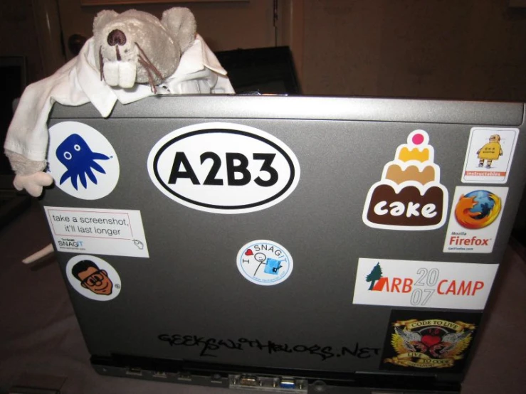 a laptop covered in stickers and magnets