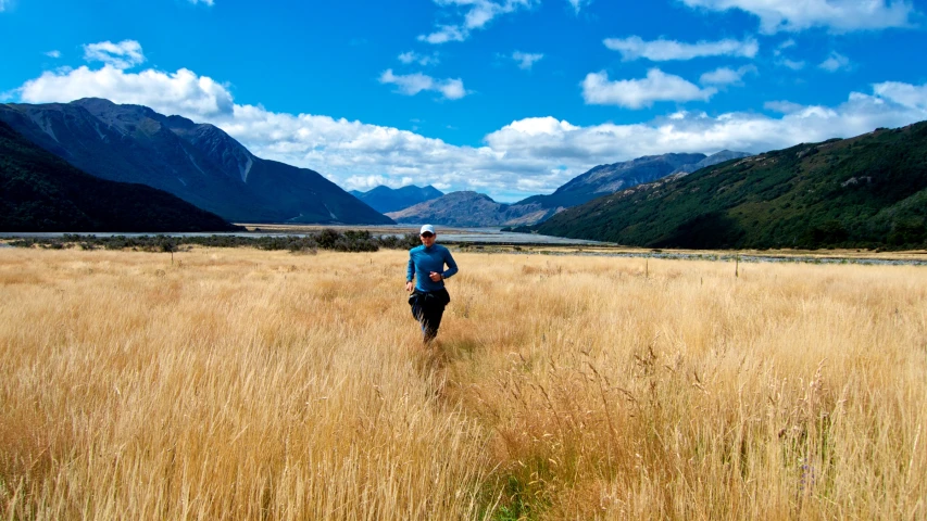 the man is running through an empty field