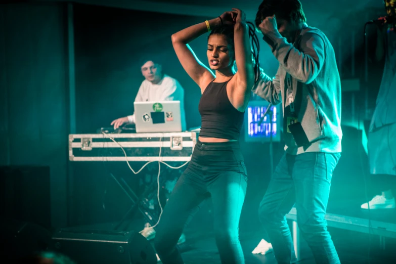 a couple dance together on stage as they watch another person perform