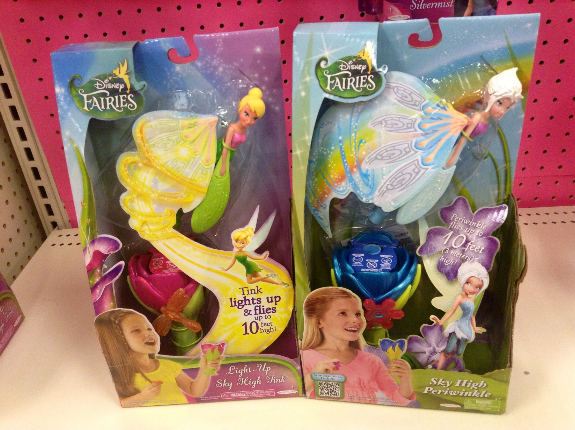 two princess toys in plastic cases on a shelf