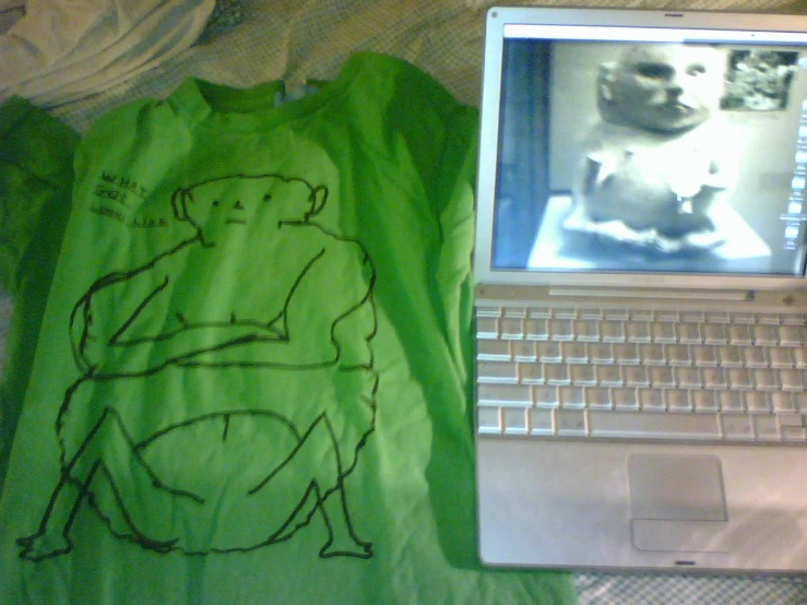 an image of a t - shirt has a mouse and computer screen next to it