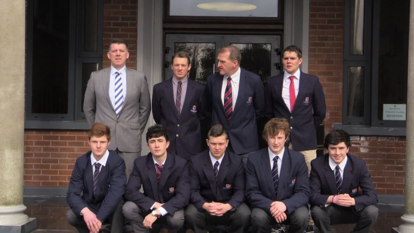 a group po of a team of men in suits and ties