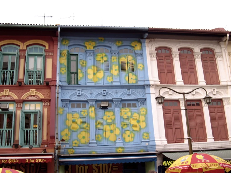 multiple colorful buildings are shown behind open doors