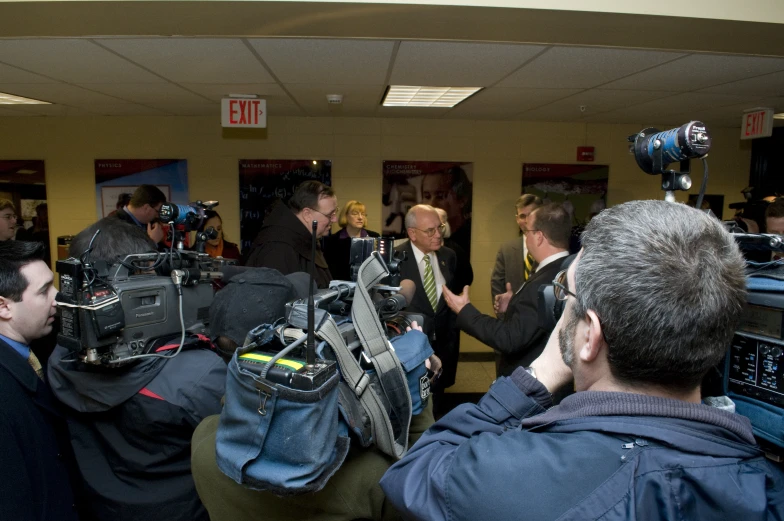 a group of people wearing cameras are standing in a room