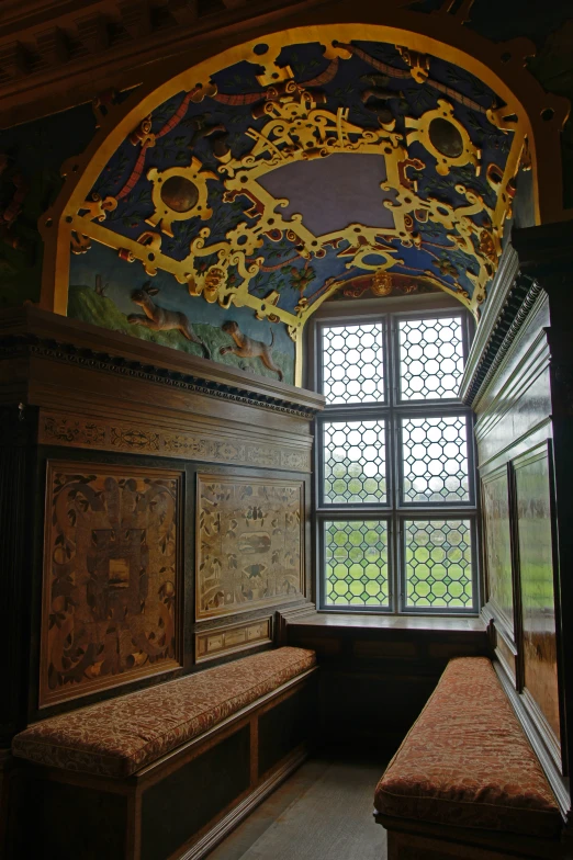 two long benches sit under a painted ceiling