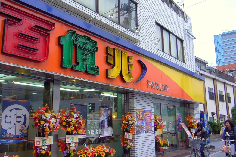 a busy street with colorful buildings and flowers