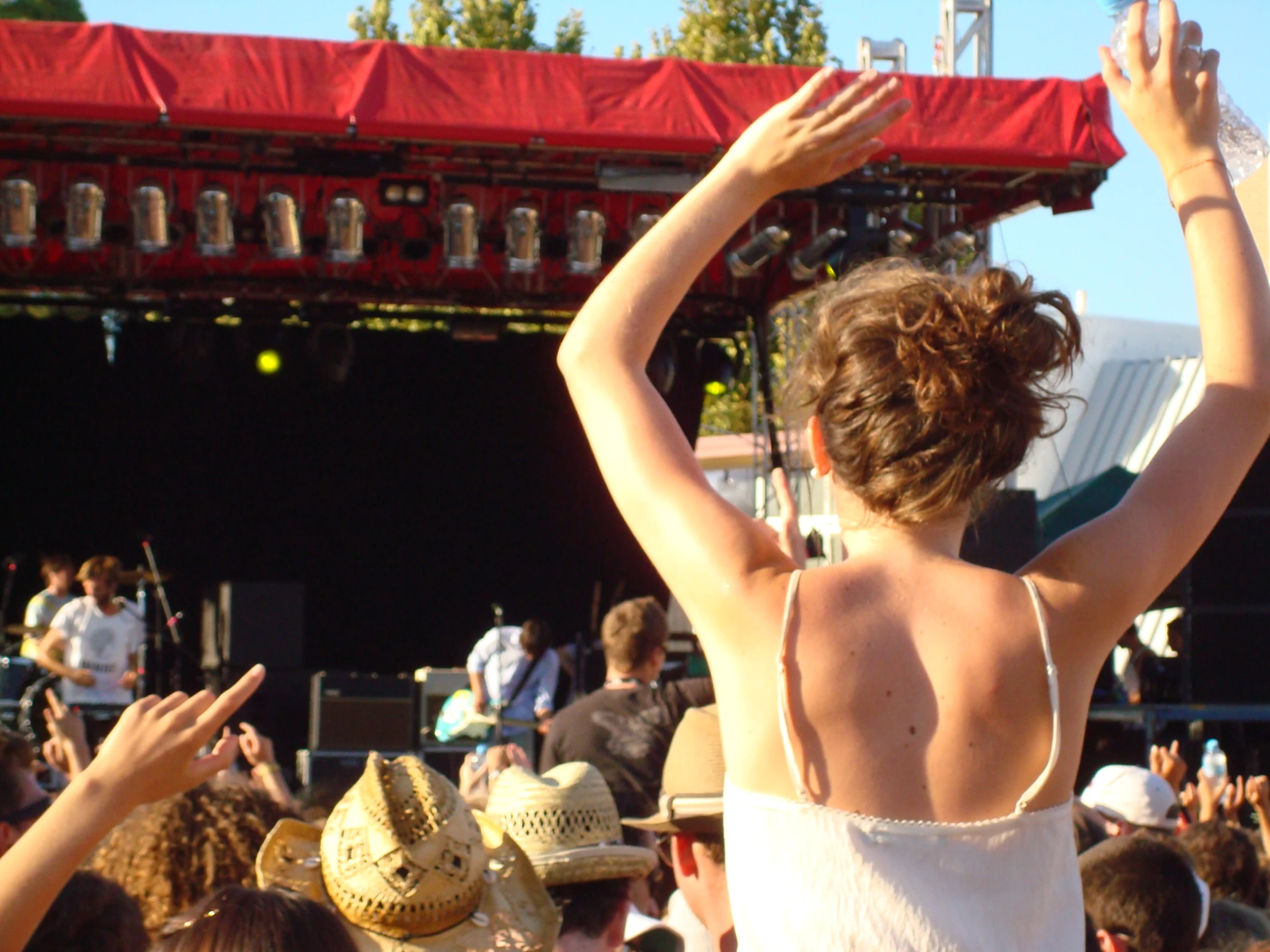 the girl in a white top is playing with her hands