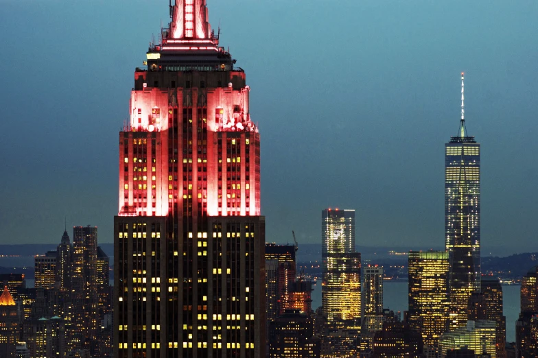 a very tall building lit up in red and white