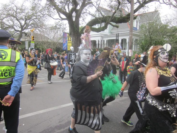 people are walking down the street in a parade