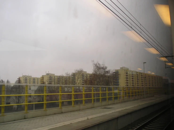 a train traveling down tracks past tall buildings