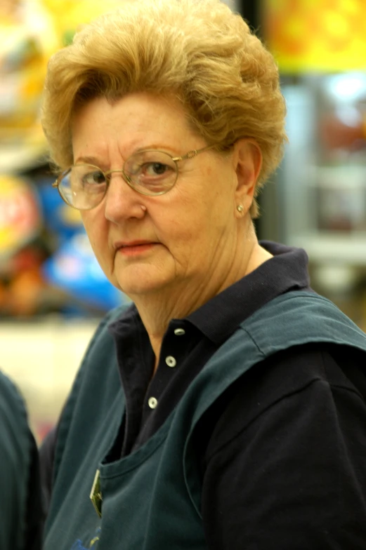 an older woman in glasses is standing outside
