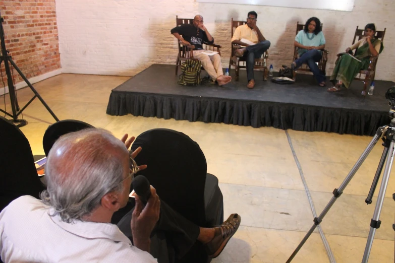 a group of people sitting on top of chairs