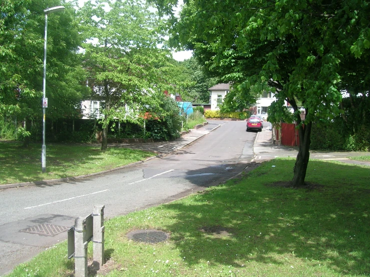 a car driving down the road near a street light