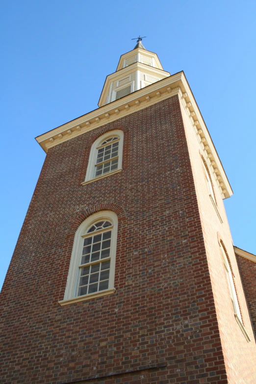 a very tall red brick building with a stop sign in front of it