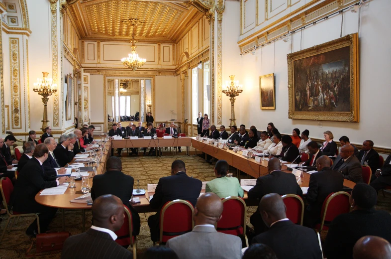 a large room with several people in formal attire