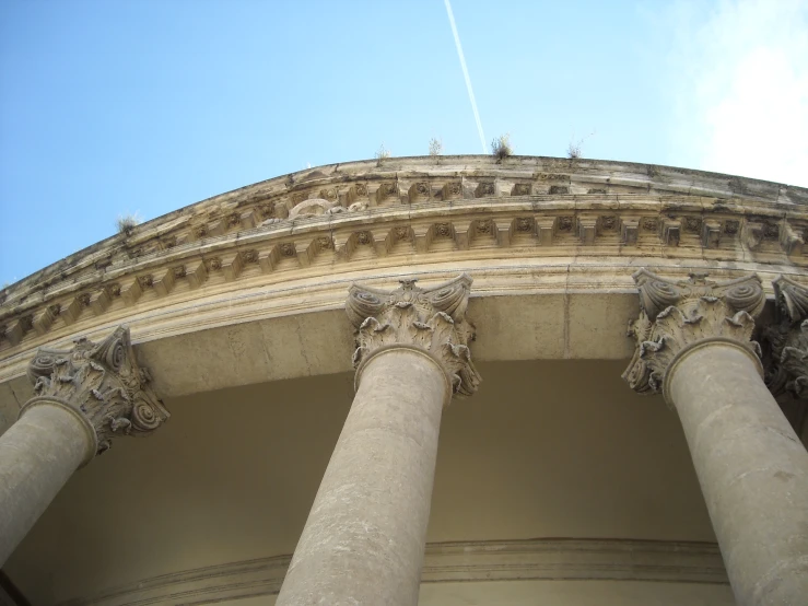 many very big beautiful pillars with some statues on them