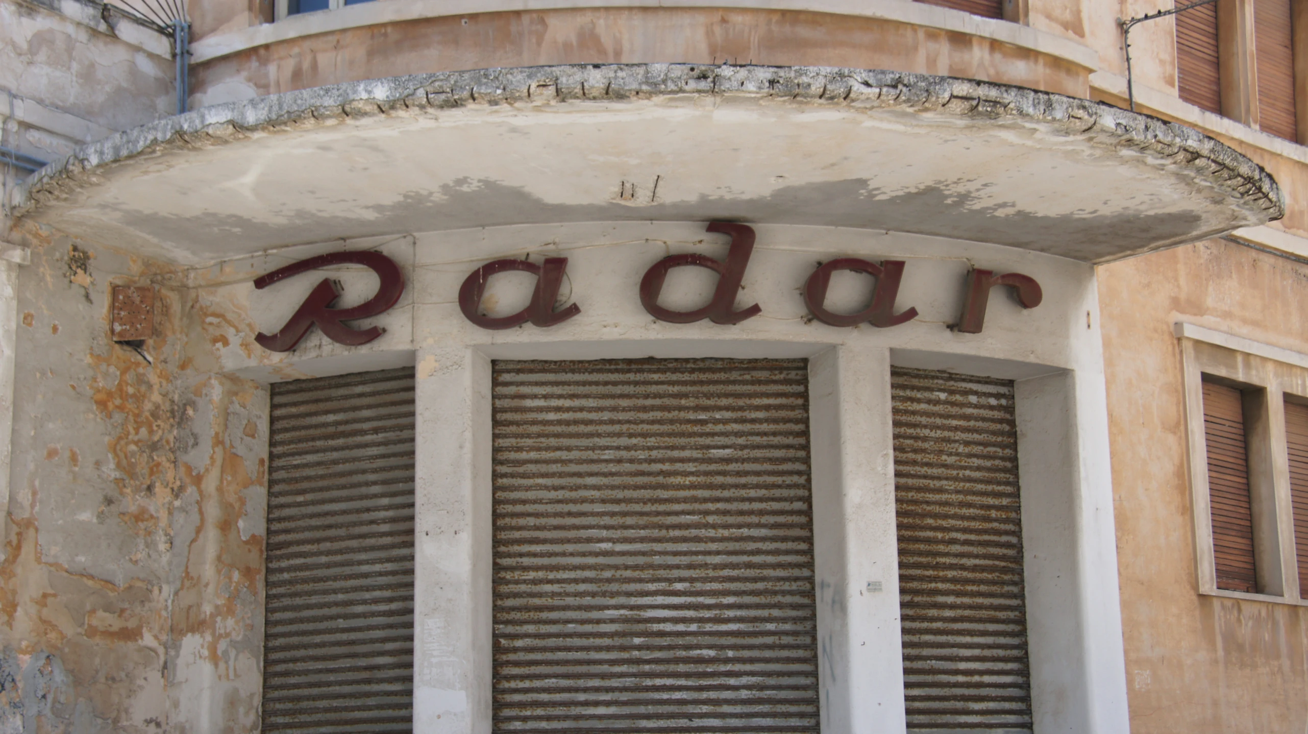 the front of a building with a radal sign on the wall