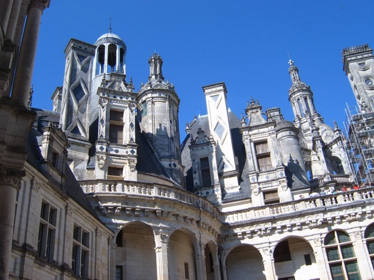 the front view of a building with two clock towers