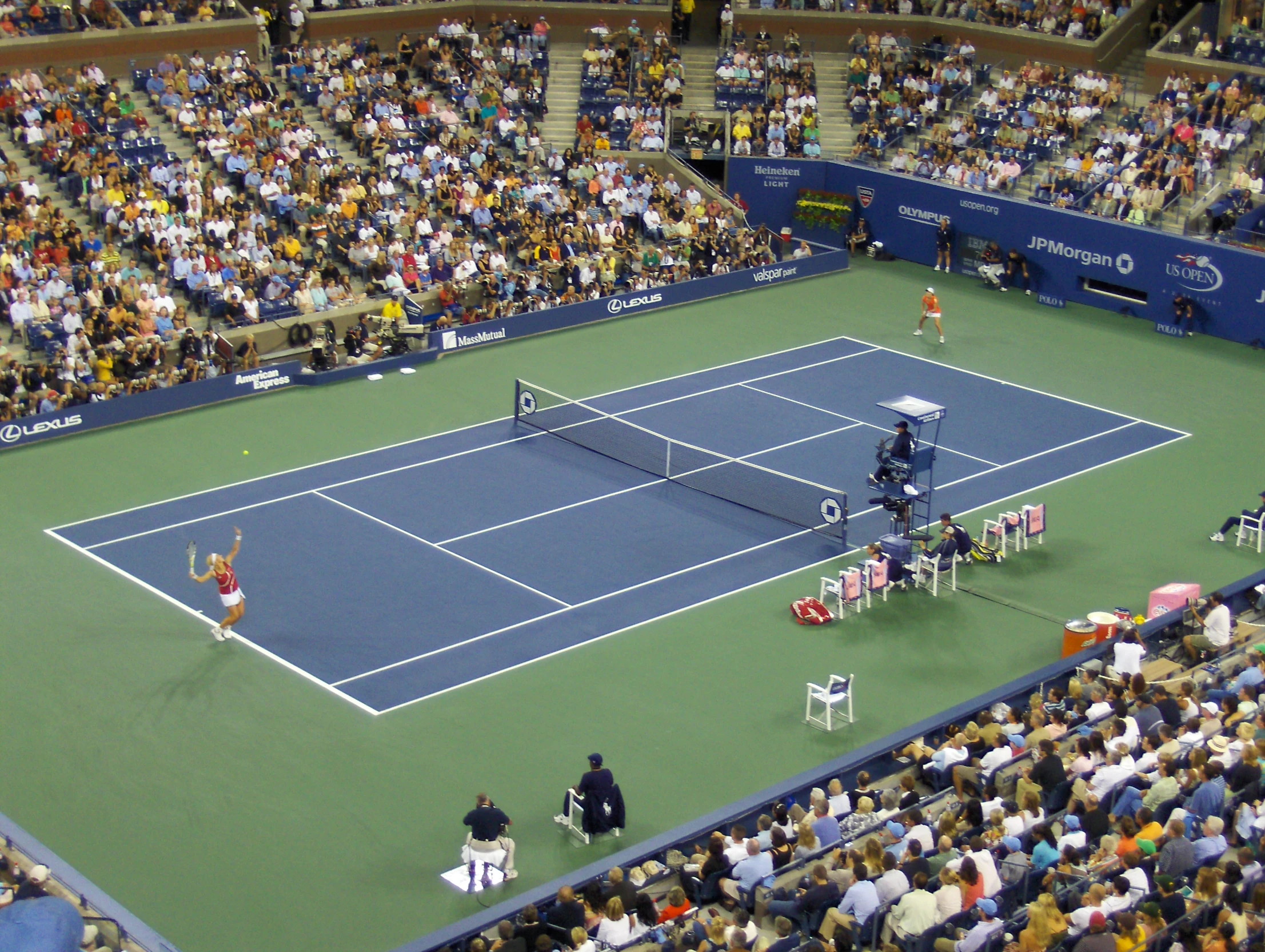 a professional tennis game on a blue and green court