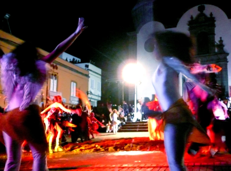 two dancers are dancing together on a brick floor