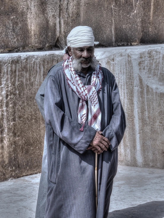 a old man is standing on the side walk