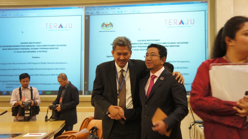 two men in suits and ties standing next to each other