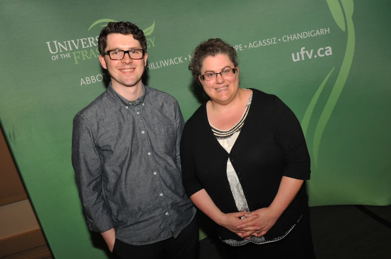 two people are posing for a po at an event