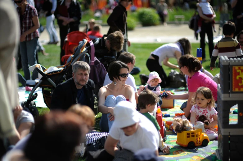 a very large group of people in a park playing