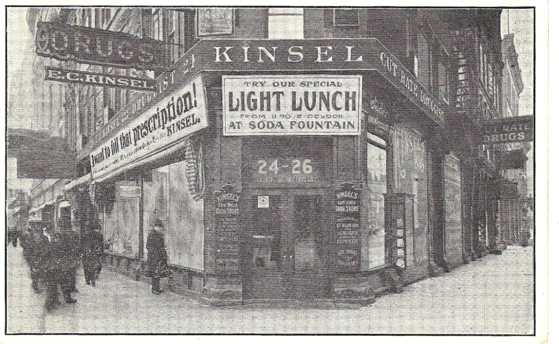 an old po shows a building with several signs hanging on the front