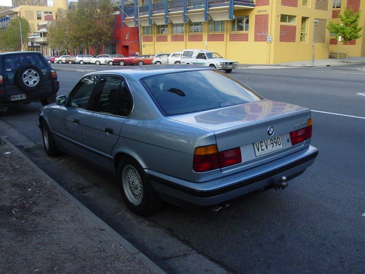 two cars parked next to each other on the street