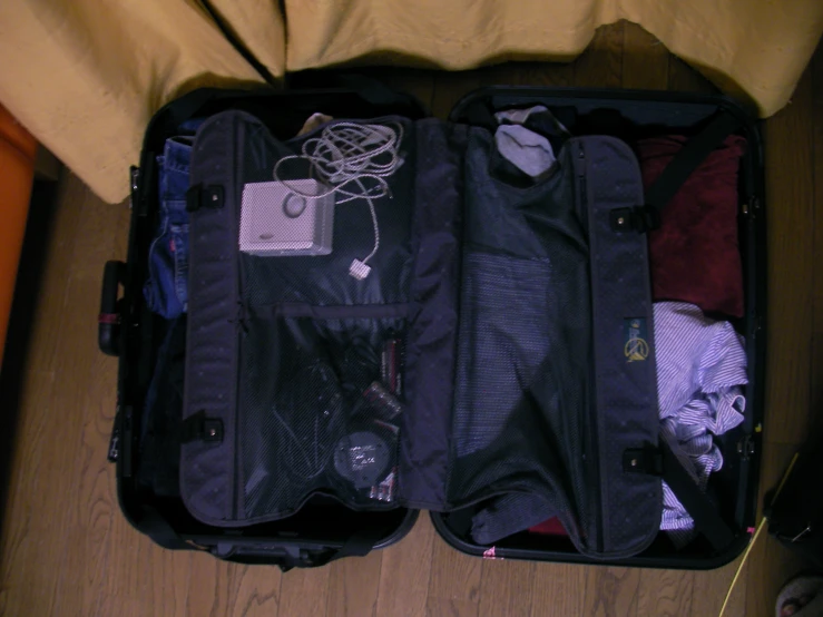 an open luggage bag packed with clothes