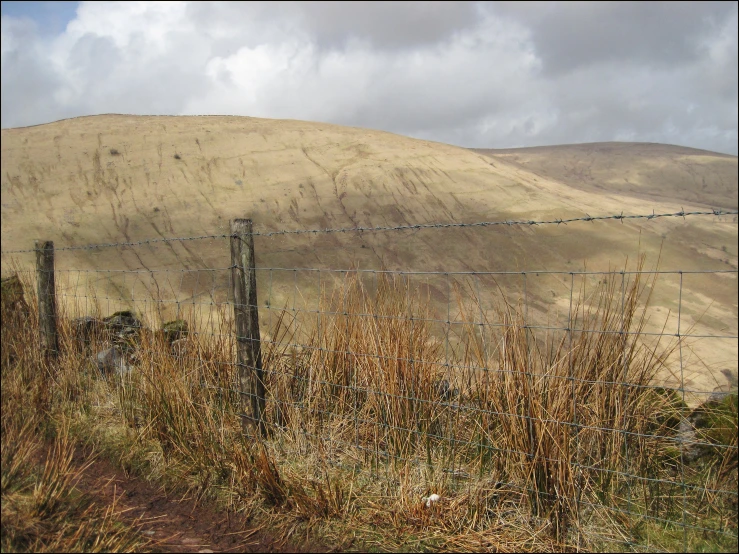 a long fence and a big hill